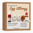 Box of homeopathic remedies for egg allergy with cartoon eggs and bottles on a beige background.