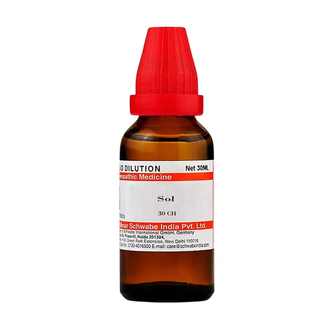 Bottle of homeopathic medicine with a red cap on a white background