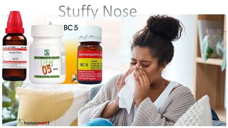 Woman with a stuffy nose using tissue, with homeopathic medicine bottles displayed.