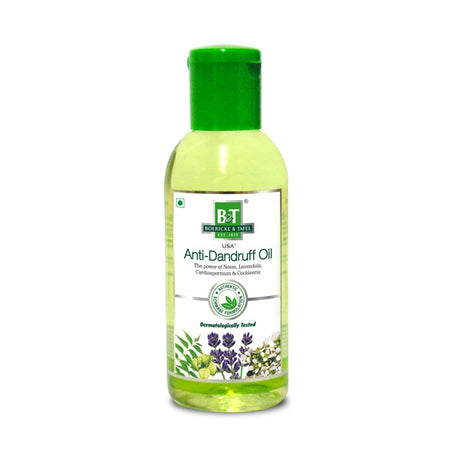 Bottle of Anti-Dandruff Oil with green cap on a white background