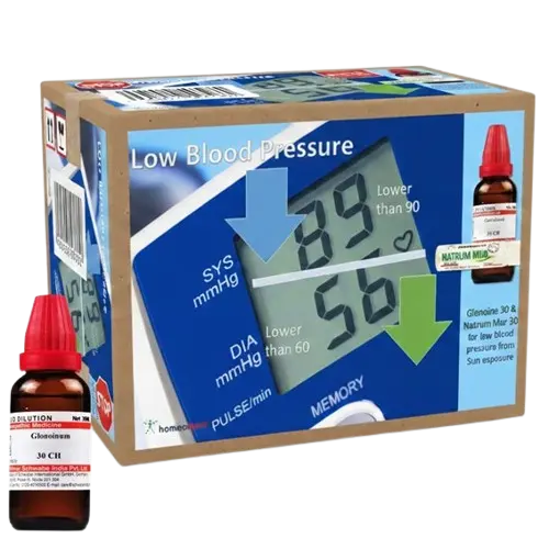 Blood pressure monitor with homeopathic medicine bottles on a white background