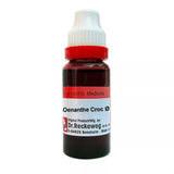 Bottle of Oenanthe Croc with red liquid and white cap on a white background