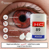 Eye with redness and a bottle of Haslab HC 89 Homeopathic Complex Tablets on a beige background and eye disorders icons