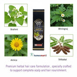 Carmy Black K2 hair oil packaging with images of Brahmi, Bhringraj, Arnica, and Shikakai plants on a white background.